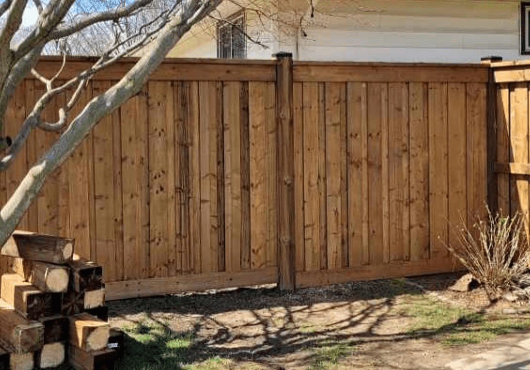 Board and batten fence with top fascia board